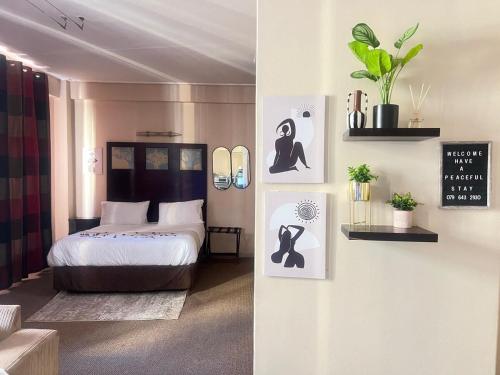 a bedroom with a bed and a clock on the wall at Peaceful stays in Mapungubwe in Johannesburg