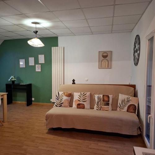 a bedroom with a bed in a room with green walls at Gite De La Baguelande in Les Andelys