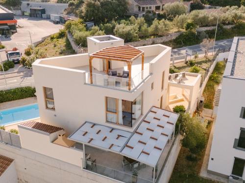 an aerial view of a white house with a swimming pool at Holiday Home A'more Preko Ferienhaus in Preko Insel Ugljan by Interhome in Preko