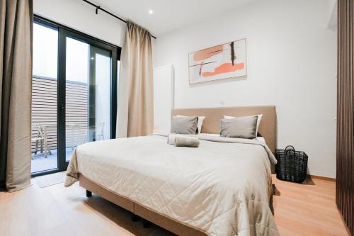 a bedroom with a large bed and a large window at Appartement en plein centre-ville in Liège