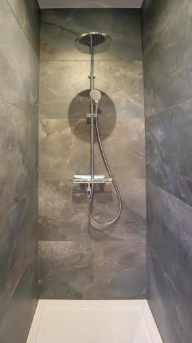 a shower in the corner of a bathroom at Appartement en plein centre-ville in Liège