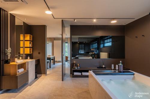 a large bathroom with a tub in the middle at Loft La Suite et sa Suite in Thimister