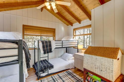 a room with bunk beds and a ceiling fan at Hot Tub & Barrel Sauna: Lakefront Innsbrook Chalet in Wright City