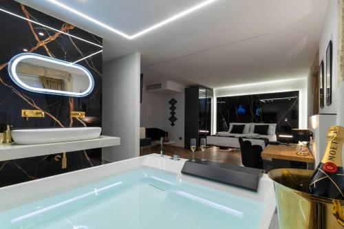 a bathroom with a large tub in the middle of a room at Flá Suite Castello in Cagliari