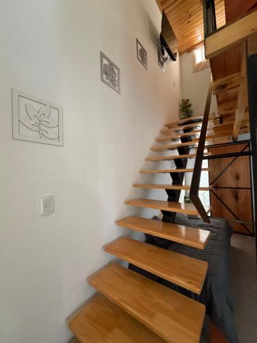 a staircase in a room with white walls and wooden floors at Elvira in Estación Circunvalación
