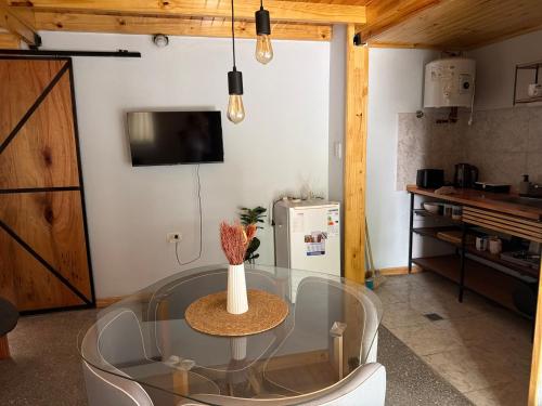 a room with a glass table with a vase on it at Elvira in Estación Circunvalación