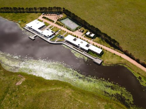 an aerial view of a group of campgrounds on the water at Lomas de San Vicente Hotel Boutique in Balneario Buenos Aires