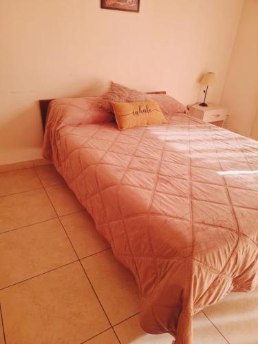 a bed with a pillow that says miracle on it at Bahia Rental 11-Departamento x dia con cochera in Bahía Blanca