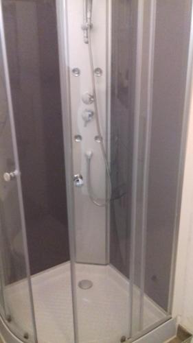 a shower with a glass door in a bathroom at Studio à la campagne in Villanova