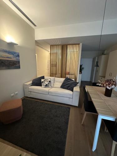a living room with a white couch and a table at Open Space - Garden & Jacuzzi in Milan