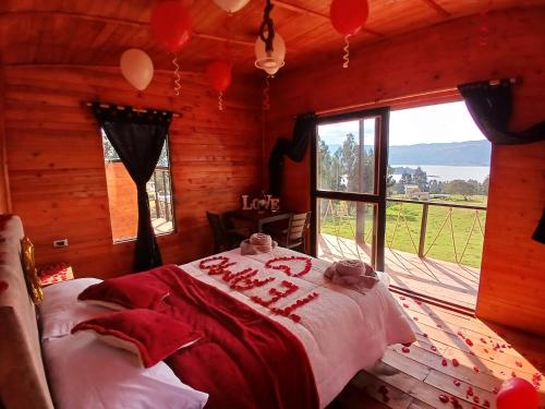 a bedroom with a bed in a log cabin at Cabañas finca las acacias in Guatavita