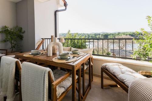 a dining room with a table and a balcony at Calidum Boutique Suites in Šibenik