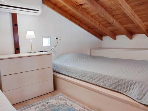 a small bedroom with a bed and a dresser at Emerald Blue in Skiathos