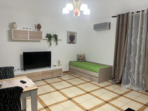 a living room with a couch and a flat screen tv at Ocean's Holiday House in Terrasini