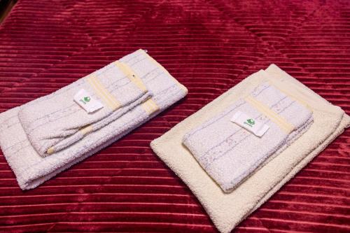 two towels sitting on top of a bed at Casa da Eira in Campo do Gerês