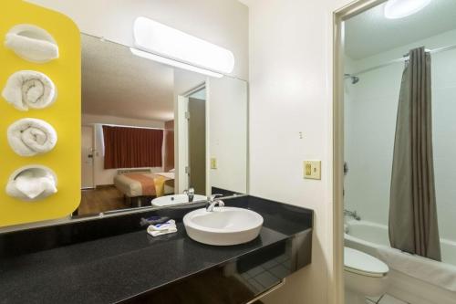 a bathroom with a sink and a mirror at Motel 6-Crawfordsville, IN in Crawfordsville