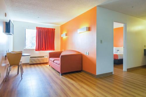 a room with a couch and a table and a bed at Motel 6-Jonesboro, GA in Jonesboro