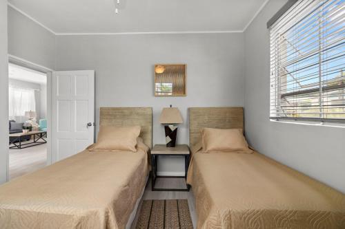two beds sitting next to each other in a room at Palasette Dover Gardens Barbados in Christ Church