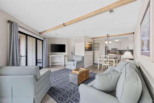 a living room with white furniture and a dining room at Chelsea House unit 201 in Myrtle Beach