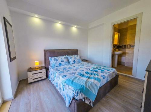 a bedroom with a bed and a bathroom with a shower at GHouse in Gallipoli