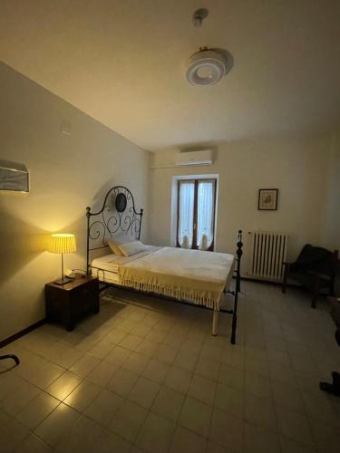 a bedroom with a bed and a lamp and a window at Casa Aurora in Borgoforte