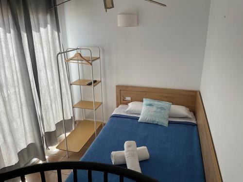 a bedroom with a bed with two towels on it at Apartamentos S'Avaradero in Es Pujols