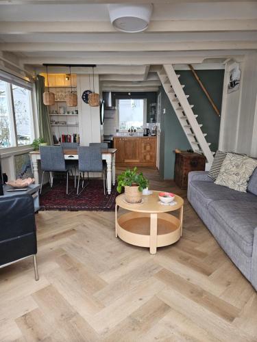 a living room with a couch and a table at Lovely holiday house in Durgerdam in Amsterdam