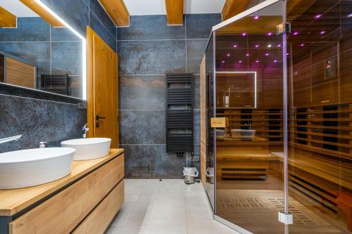 a bathroom with a shower and a sink at Roubenka Pastvina in Rudník