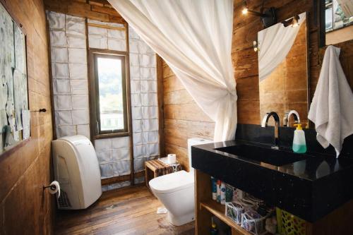 a bathroom with a toilet and a sink at Casa Rover - Floripa in Florianópolis