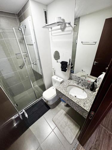 a bathroom with a shower and a toilet and a sink at Suíte Master Rio de Janeiro Próximo ao Rio Centro 9 Andar! in Rio de Janeiro