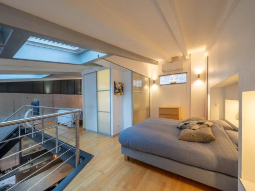a bedroom with a bed and a staircase in it at LE LOFT 67 in Strasbourg