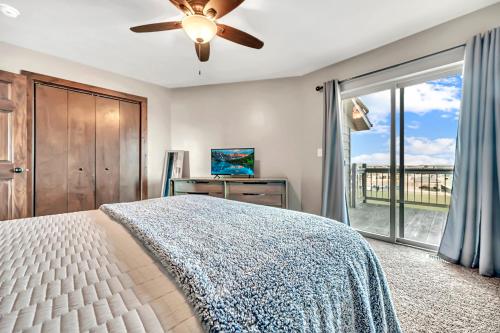 a bedroom with a bed and a ceiling fan at Bridges Bay Vacation Cabin 278 in Arnolds Park
