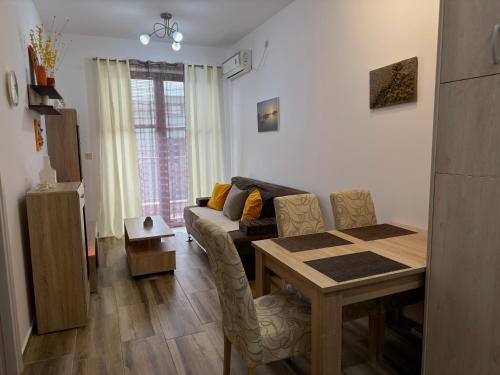 a living room with a table and a couch at Modern Apartment with Balcony in Przno - Near Beach in Pržno