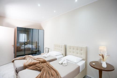 a bedroom with two beds and a mirror at Luxury and Cozy Chios in Chios