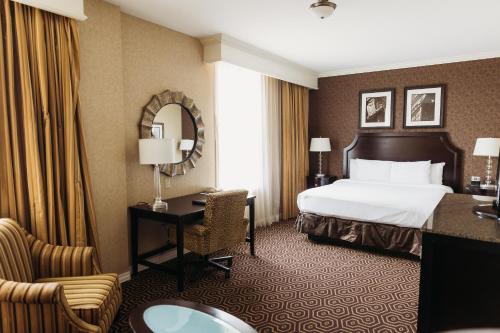 a hotel room with a bed and a desk at Hotel Julien Dubuque in Dubuque