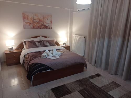 a bedroom with a bed with two stuffed animals on it at SOUROTI Pinios House in Sourotí