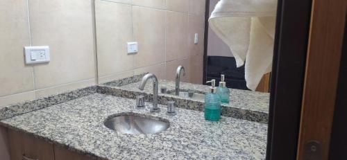 a bathroom counter with a sink and a mirror at Victoriano in La Rioja