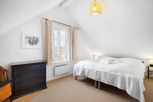 a white bedroom with a bed and a window at BV435-Blavand-Horns-Bjerge-3-59 in Blåvand