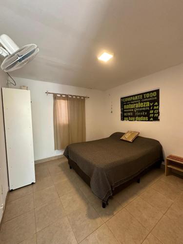 a bedroom with a bed and a sign on the wall at Huaka Guesthouse and Hostel in Cafayate