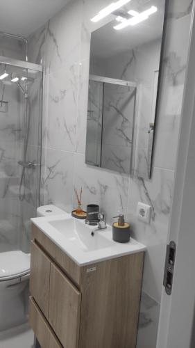 a bathroom with a sink and a toilet and a mirror at HOUSE DOURO in Peso da Régua