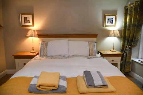 a bedroom with a bed with two towels on it at No6 @ Globe Lane,Alston in Alston