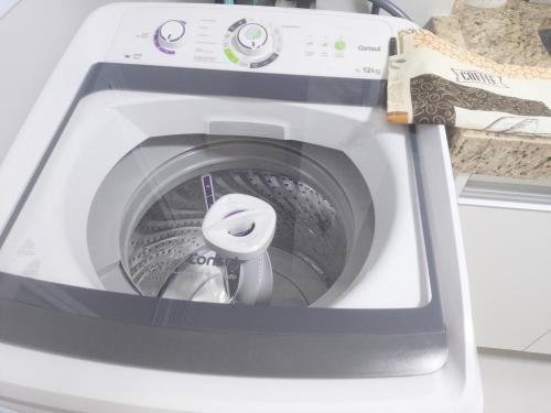 a washing machine with its door open on a counter at Juhh Bella in Botucatu