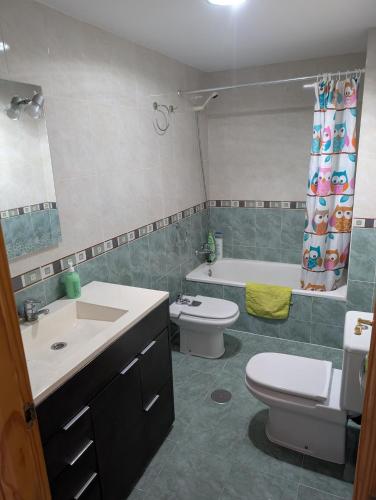 a bathroom with a sink and a toilet and a tub at San Juan nº10 in Jaén