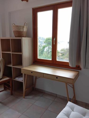 a desk in front of a window in a room at Andros Summer House II in Andros