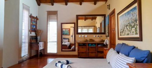 a living room with a blue couch and a mirror at Coming Home in Centurion