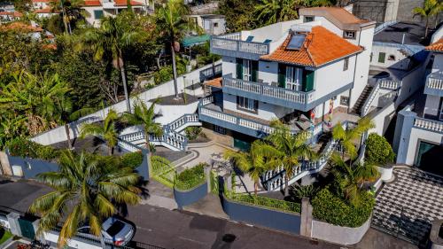 an aerial view of a house with palm trees at Cumbres Villa in Funchal