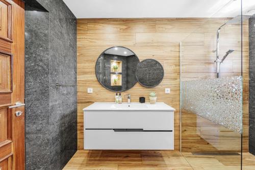 a bathroom with a sink and a mirror at Cumbres Villa in Funchal