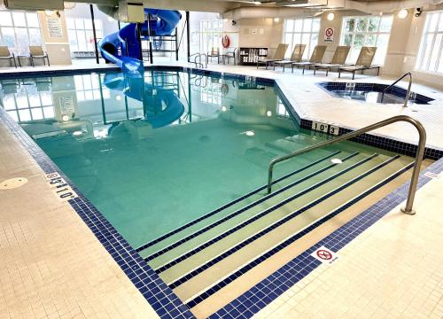 a large swimming pool with a slide in it at Holiday Inn Express Airdrie by IHG in Airdrie