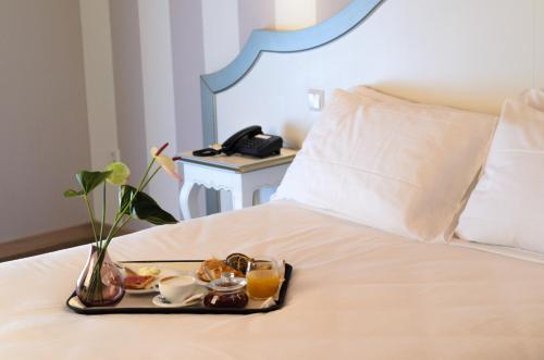 a tray of food on a bed with a breakfast at Fracanzana Hotel in Montebello Vicentino