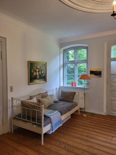a living room with a couch and a window at Inseldomizil Brummers Gaard in Haderslev